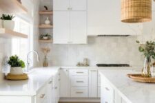 29 a serene white kitchen with a zellige tile backsplash, open shelves, a large kitchen island and woven pendant lamps