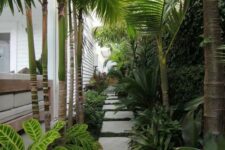 33 a gorgeous tropical side yard with pavers, greenery and lots of tropical plants and a living wall is a lovely and vibrant space