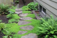 34 a little cozy side yard with an irregular stone path, greenery, moss and ferns is a great shadowy space to enjoy