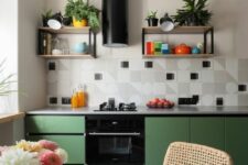 36 a bright modern kitchen with matte green lower cabinets, square tiles with a geo print, a black hood and some shelves