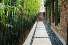 36 a long and narrow side yard with pebbles and pavements plus bamboo that lines up the path is a cool and chic space