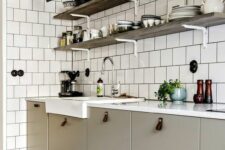44 a greige Scandinavian kitchen with leather pulls, a white square tile wall and open shelves and grey sconces