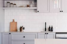 45 a grey Scandinavian kitchen with shaker cabinets, white stone countertops, white square tiles on the backsplash and pendant lamps