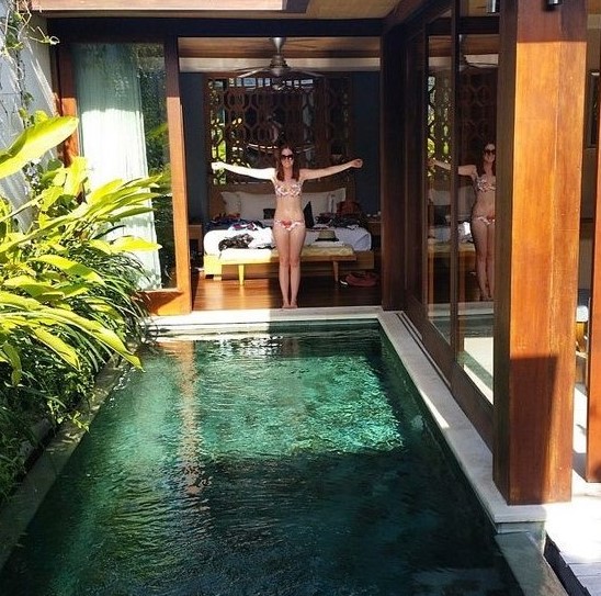 a small backyard pool lined up with greenery and with an entrance right from the bedroom is a wonderful idea
