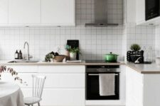 47 a minimal Scandinavian kitchen with sleek white cabinets, stone countertops and a white square tile backsplash