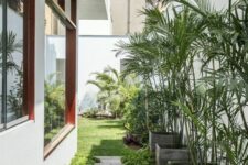 48 a modern side yard with a stone path, greenery and potted plants is a cool and chic space you may pull off