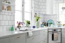 52 a Nordic kitchen with grey lower cabinets, white square tiles on the walls, a round hood and open shelves is lovely