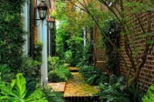 53 a shadowy side yard clad with stones and with greenery and trees around is a lovely and welcoming space