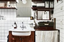 57 a Scandinavian bathroom with white square tiles, brown ones on the floor, a dark-stained vanity and matching shelves