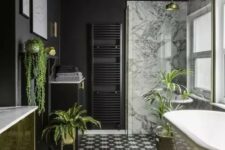 61 a stylish modern bathroom done with matte black walls, a gold vanity, gold planters and accessories plus cool monochrome tiles