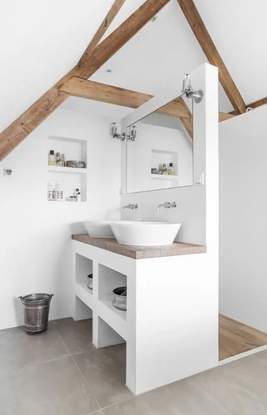 a modern neutral bathroom with white walls, large scale tiles on the floor, wooden beams, a vanity with two sinks