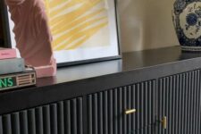 03 a beautiful black sideboard with black fluted panels and gold handles, with bright and catchy decor is amazing for a modern space