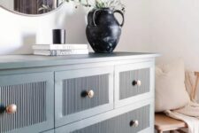 08 a blue fluted IKEA dresser hack with copper knobs and lovely decor on it is a stylish and chic idea for a modern space