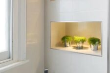 08 a contemporary bathroom with lit up niche shelves that feature storage and display space and add decorative value