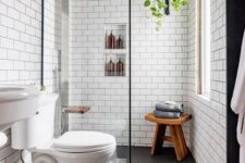 09 a contemporary bathroom with penny and subway tiles, built-in shelves, a sink and a wooden stool