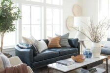 10 a stylish modern and boho living room with a navy leather couch accessorized with various pillows
