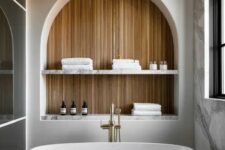 a stylish bathroom with a spacious arched niche