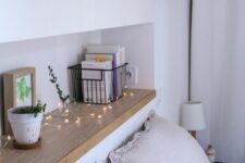 12 a Scandinavian bedroom with a long and narrow headboard niche used for decor and storage is a lovely and airy space