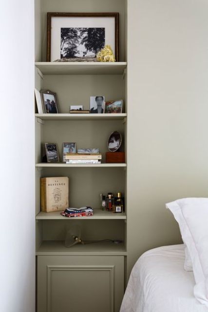 A bedroom niche with shelves and a built in cabinet used for displaying stuff and adding decorative value