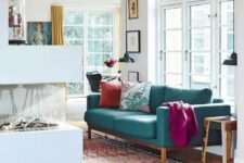 16 a contemporary living room with a fireplace, a modern turquoise sofa and bright textiles, pendant lamps and printed mini rugs