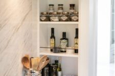 19 niche shelves next to the cooker, with oils, porcelain and spices are a very functional and practical solution for any kitchen