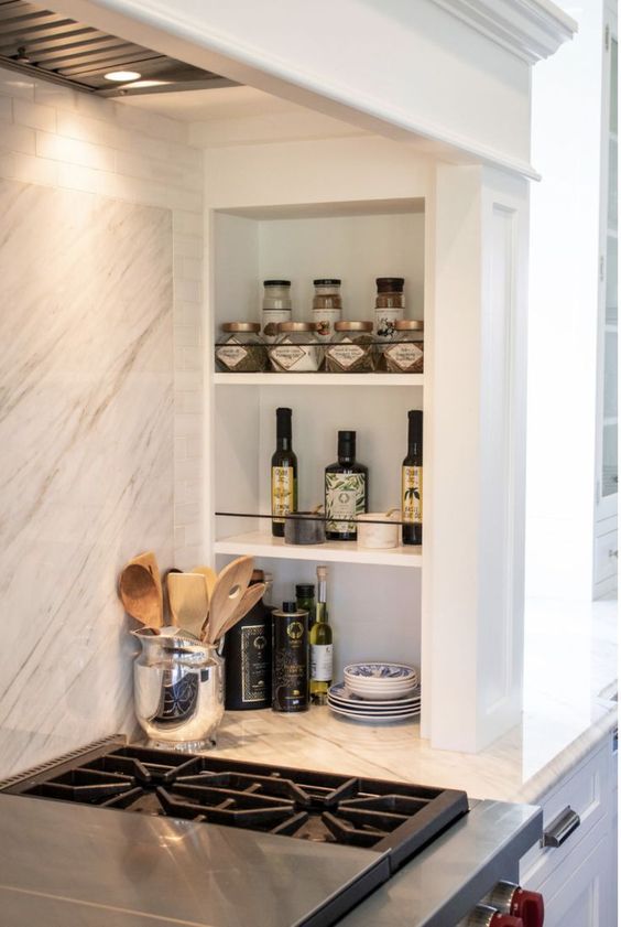 niche shelves next to the cooker, with oils, porcelain and spices are a very functional and practical solution for any kitchen