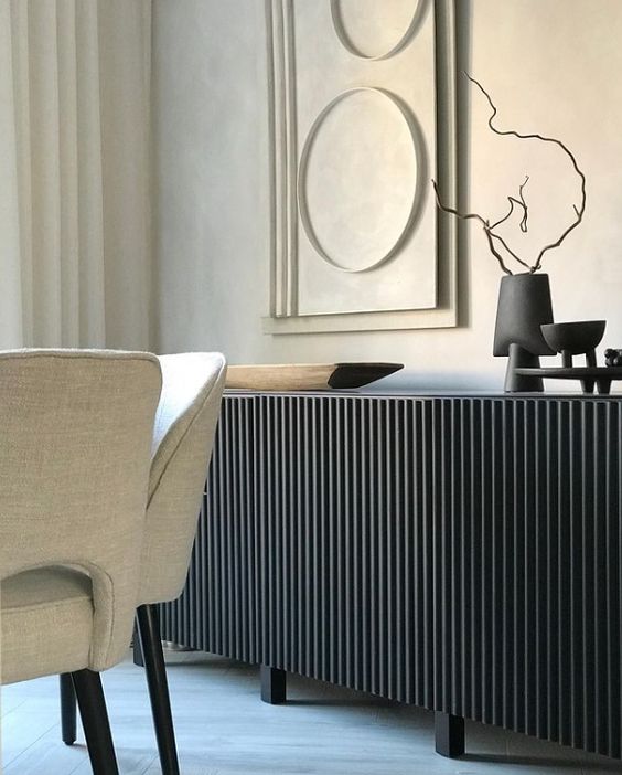 an IKEA Besta hack with black reeded panels, beautiful black decor and some art around for a luxurious look