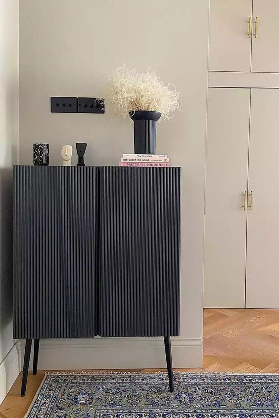 an IKEA Ivar cabinet hacked into a stylish and trendy black fluted piece on tall legs is amazing