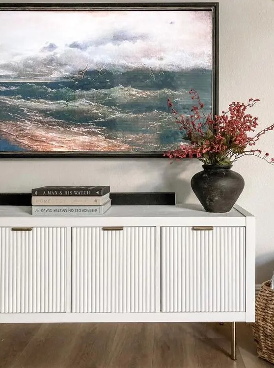 an IKEA Kallax unit renovated into a stylish fluted media console with doors and pulls looks wow