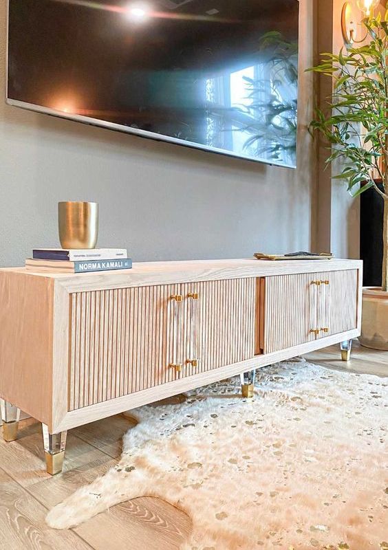 cool media consoles with fluted doors, acrylic and gold legs and matching handles will add special chic to your living room