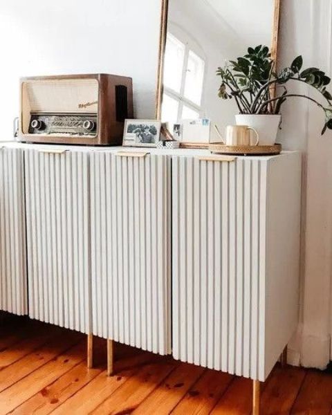 neutral fluted storage units on tall gold legs and some vintage decor will be a perfect fit for a modern or Scandinavian space