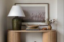44 a beautiful entryway console table with fluted legs, a table lamp, some decor, an artwork and a basket for storage is all cool