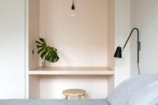 45 a minimal bedroom with a colored arched niche that is used as a tiny workspace or a vanity for makeup, with a pendant lamp