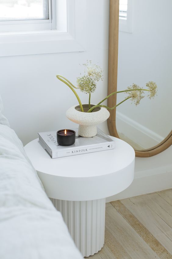 a beautiful nightstand with a reeded base and a stone tabletop is perfect for a refined bedroom in neutrals
