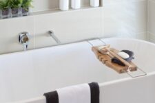 48 a stylish modern bathroom with an oval tub and a niche shelf over it, with decor and some bathroom stuff