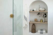 54 adding interest to the bathroom, an arched niche with shelves also provides the space with some storage