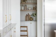 55 a white modern farmhouse kitchen with an arched niche that hides a pantry with cabinets and open shelves, a smart solution to save some pace