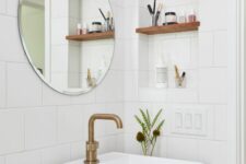 61 a chic modern powder room with white square tiles, a niche with shelves for storing small things. a stained vanity with a sink and a round mirror