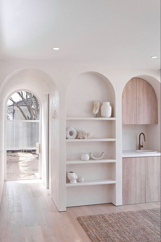 an arched niche with shelves and lovely and stylish decor will ad decorative value to your kitchen or some other space