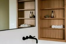 66 a minimalist bathroom with niche and shelves done with wood completely is a stylish space that adds warmth here