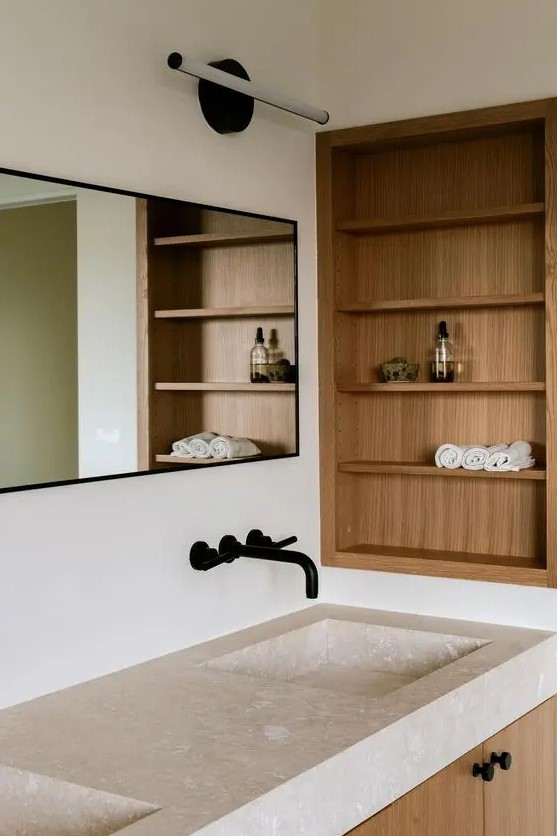 a minimalist bathroom with niche and shelves done with wood completely is a stylish space that adds warmth here
