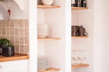 66 tall niches with timber shelves and baskets are used for storing dishes, glasses and wine are a great alternative to an upper row of cabinets