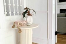 69 a small reeded side table with decor is a great addition to a modern or Scandinavian space
