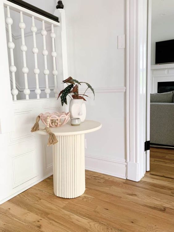 a small reeded side table with decor is a great addition to a modern or Scandinavian space