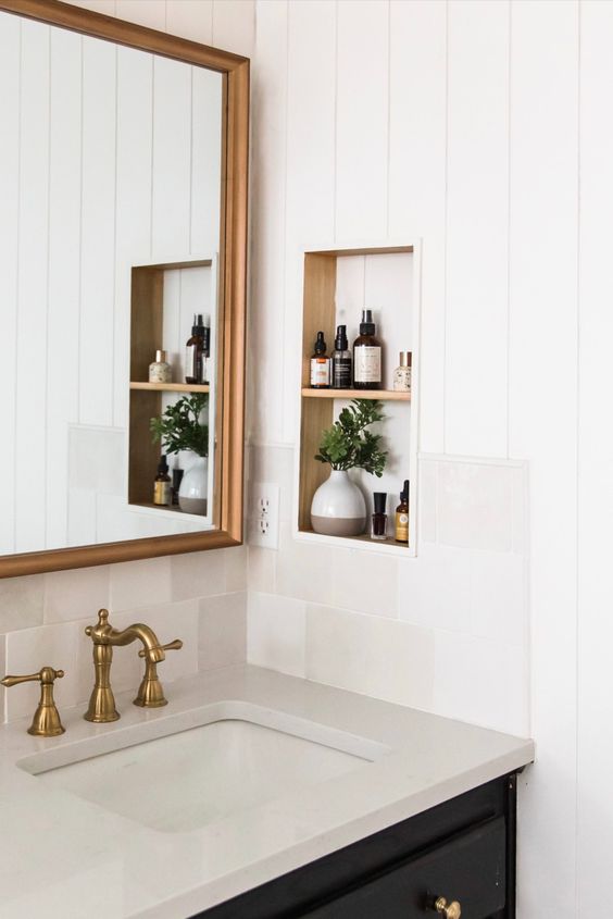 a modern farmhouse bathroom with shiplap walls and a small niche by the vanity with decor and some necessary stuff