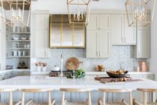 a beautiful modern farmhouse kitchen with tan cabinets, a kitchen island, a printed tile backsplash, woven stools and pendant lamps