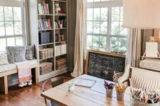 a cottage home office with a wooden desk, a chalkboard sign, a built-in storage unit and a bench is very welcoming and cool