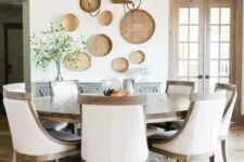 a gorgeous modern farmhouse dining room done in neutrals and with a large wooden round table