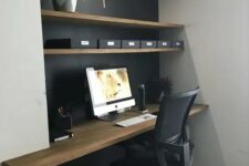 a home office in a niche, the depth of which is highlighted with a black wall and a wooden desktop