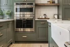 a large olive green farmhouse kitchen with shaker cabinets, white stone countertops, open shelves, a white subway tile backsplash